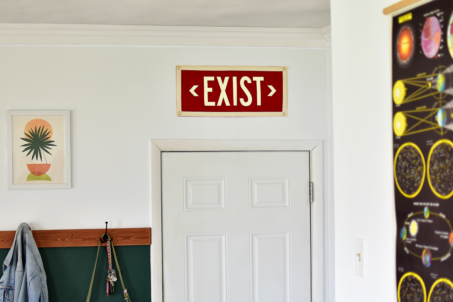 Red rectangle EXIST pennant with white border hanging in a model room