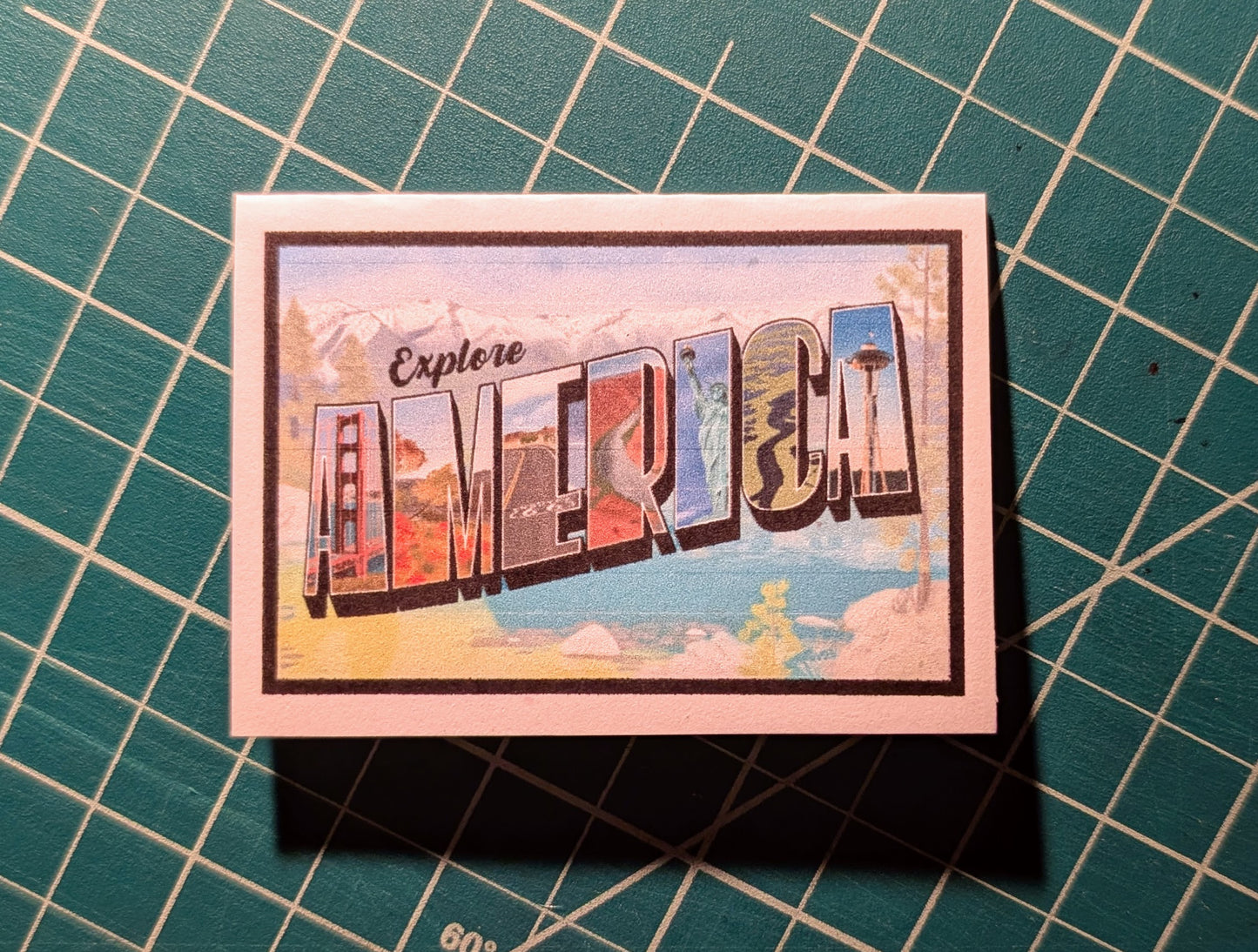 Mini card with America vintage letter art design on confetti white paper with green grid background