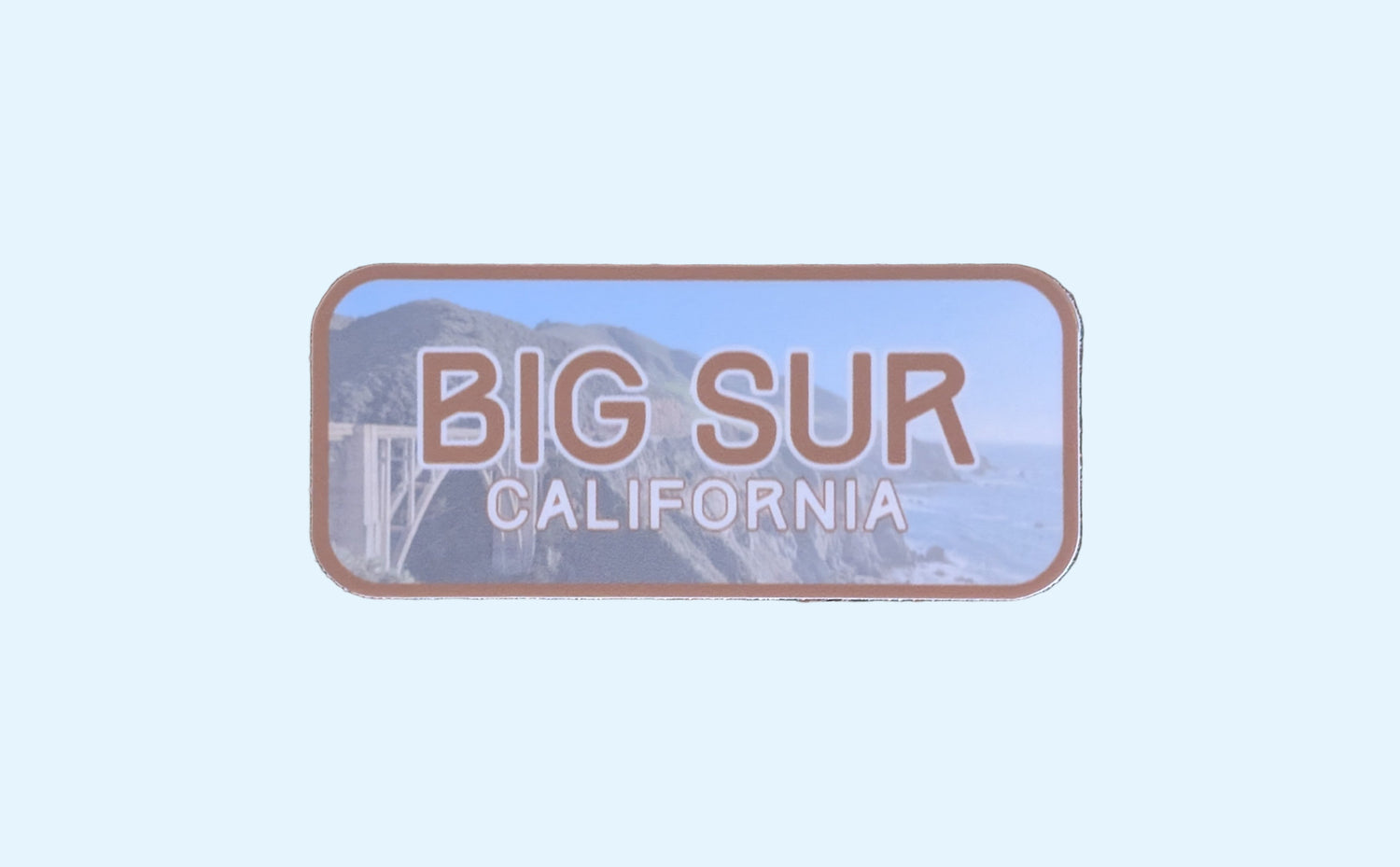 this brown blue bordered sticker represents Big Sur, featuring the famous Bixby Bridge:
