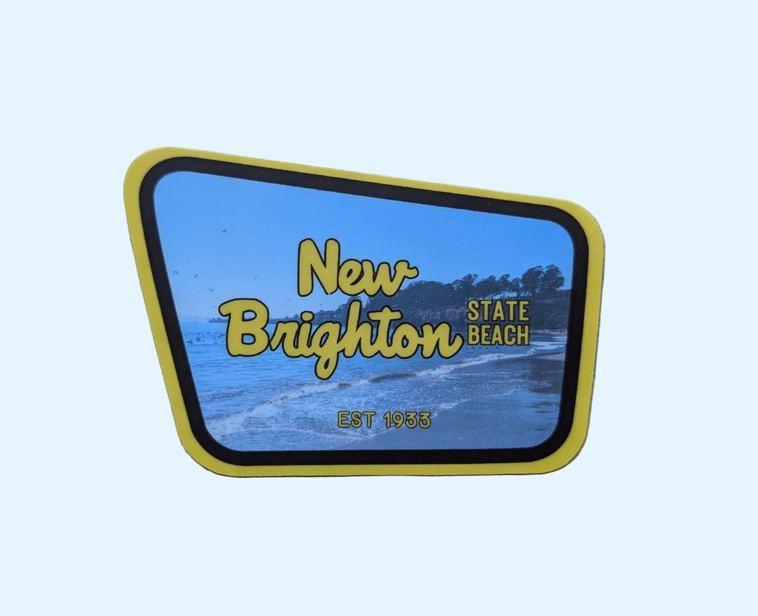 yellow + brown bordered sticker represents New Brighton State Beach with paper background