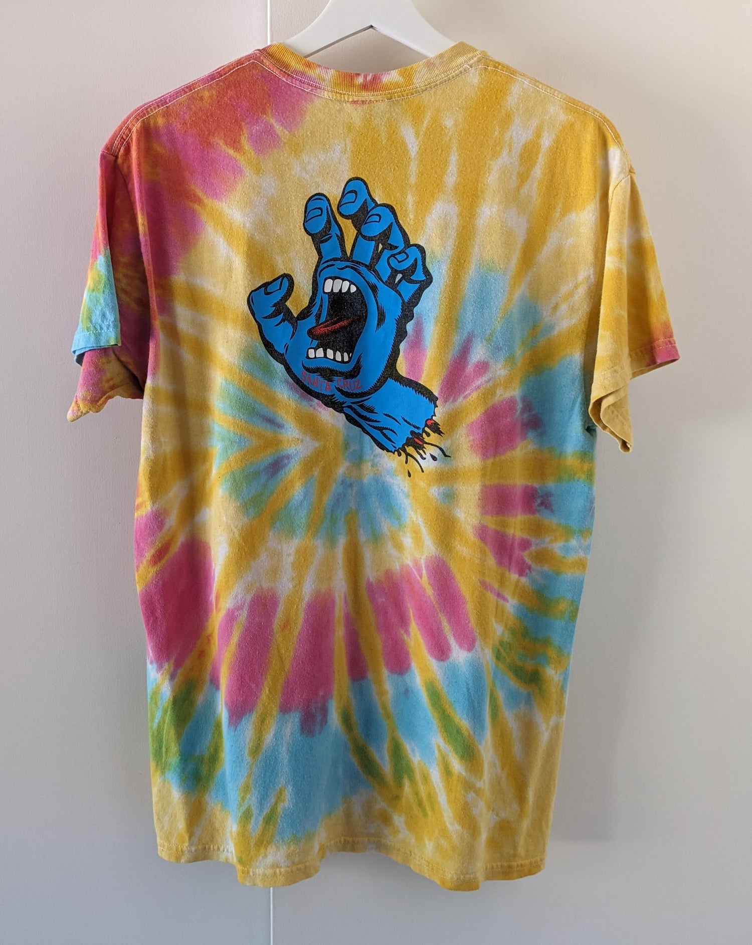 Rainbow tie dye shirt with Santa Cruz Screaming Hand in blue shirt back