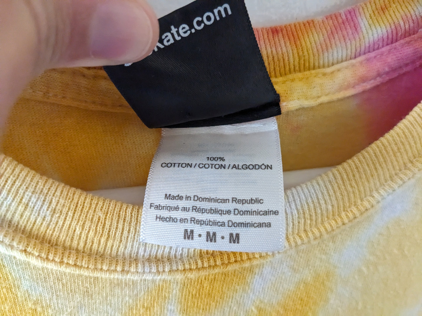 Rainbow tie dye shirt with Santa Cruz Screaming Hand in blue tag details