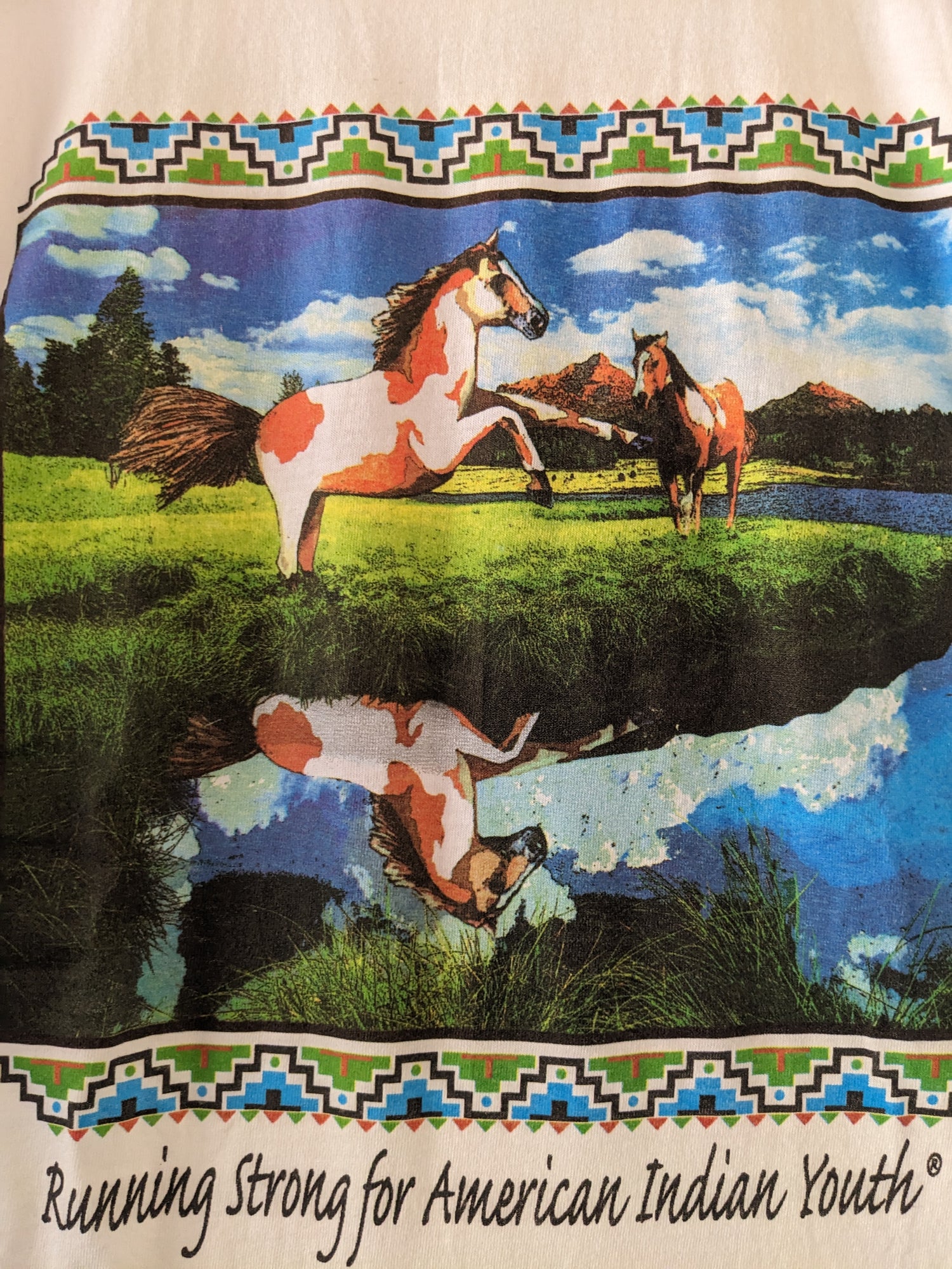 White shirt with Running Horses graphic close up