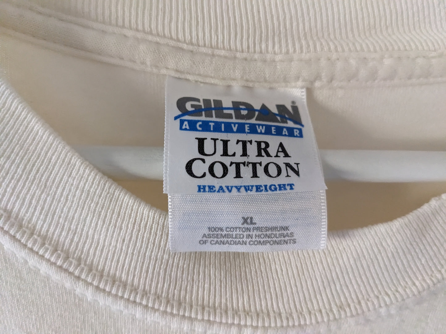 Off-white long sleeve shirt with Christmas tree with garden ornaments reading Hoe Hoe Hoe tag