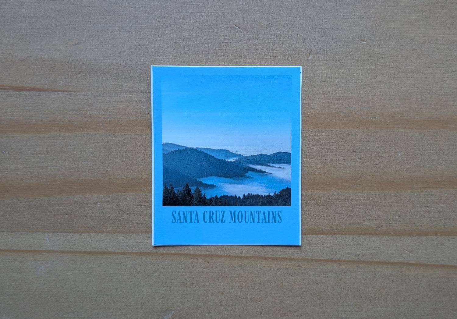 Blue bordered sticker of a photo of the Santa Cruz Mountains