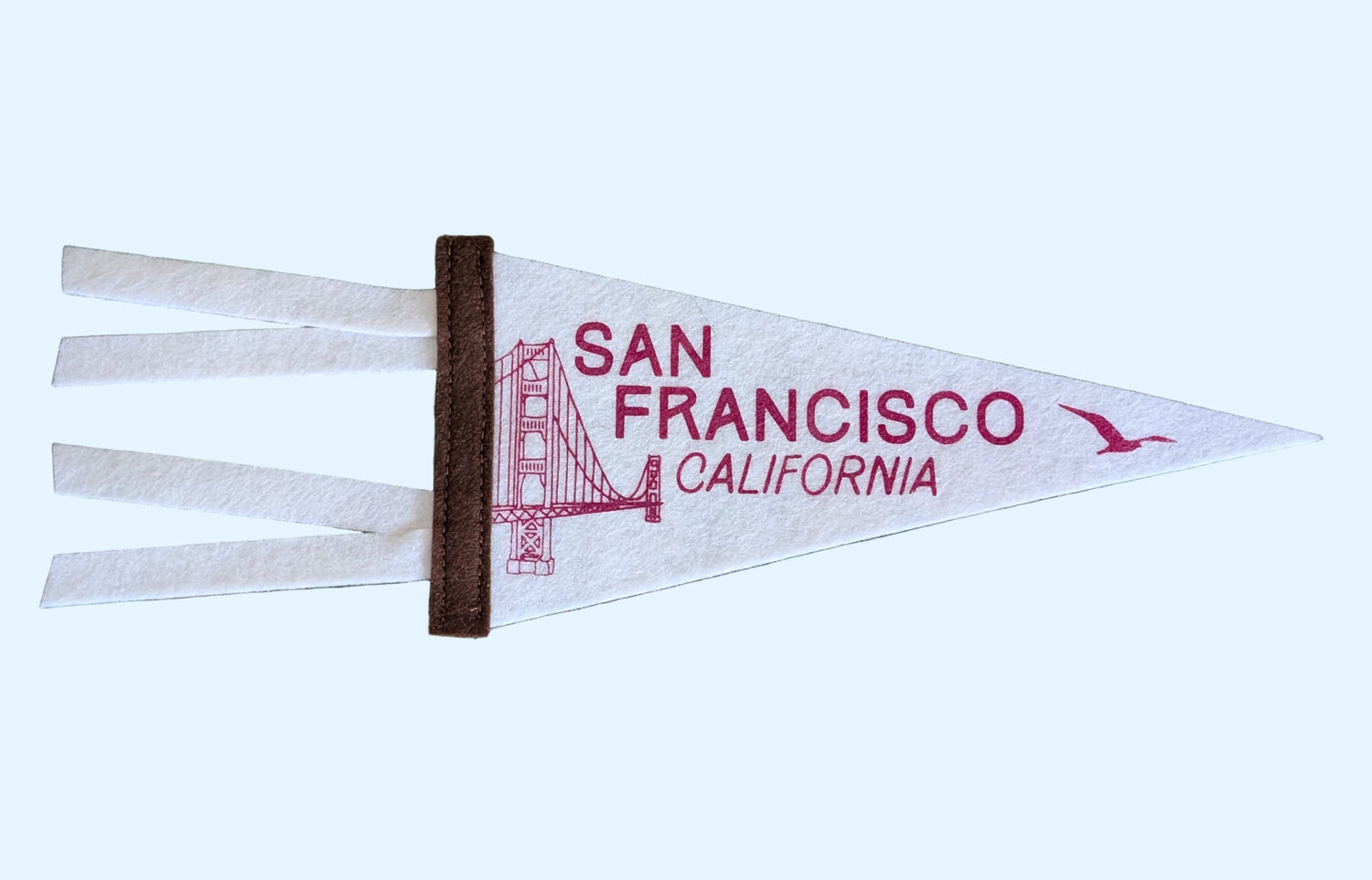 Mini soft white pennant with the words "San Francisco, California", a brown border and the Golden Gate Bridge and a seagull in red ink