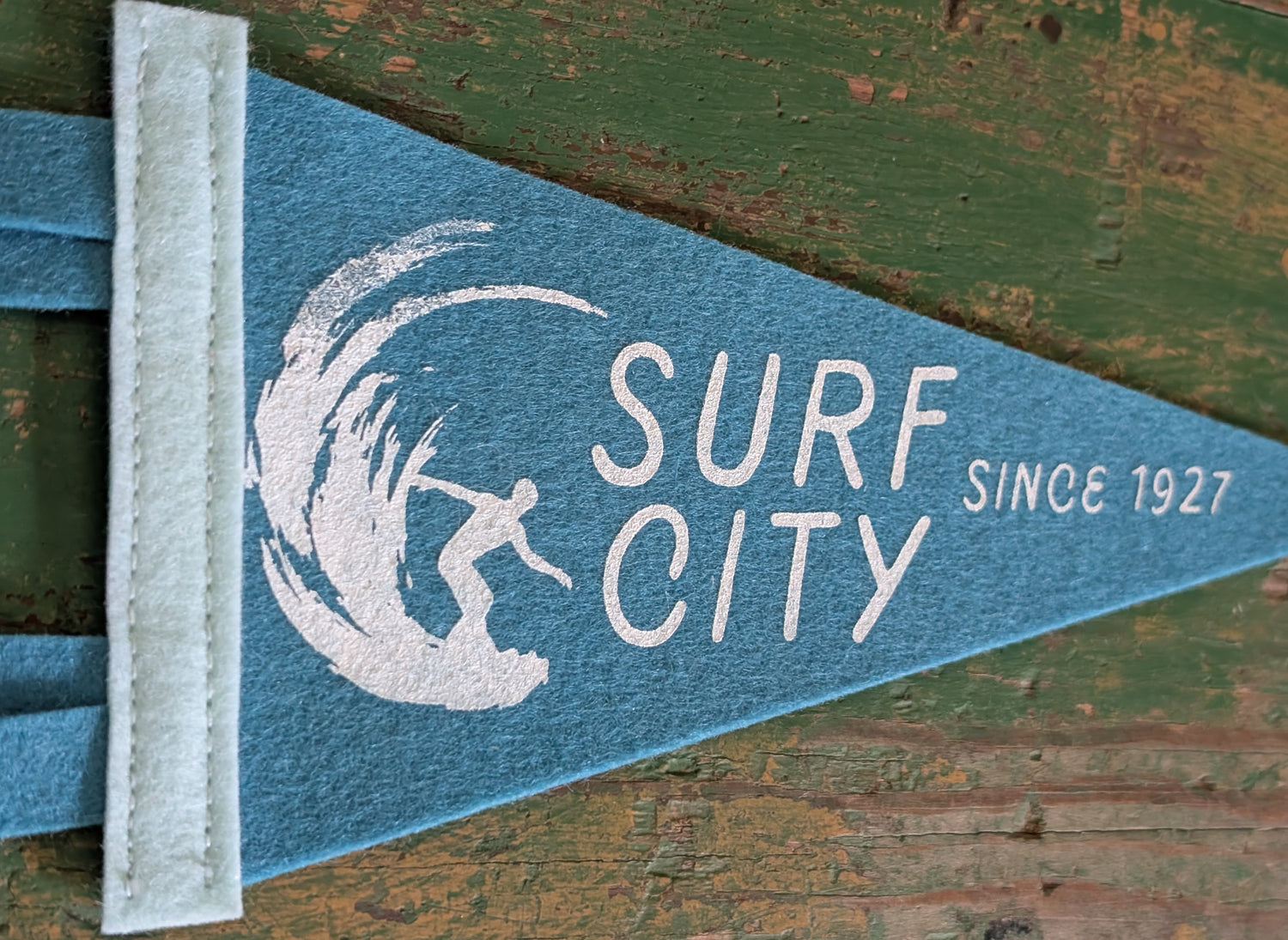 Close-up of Surf City pennant on blue felt