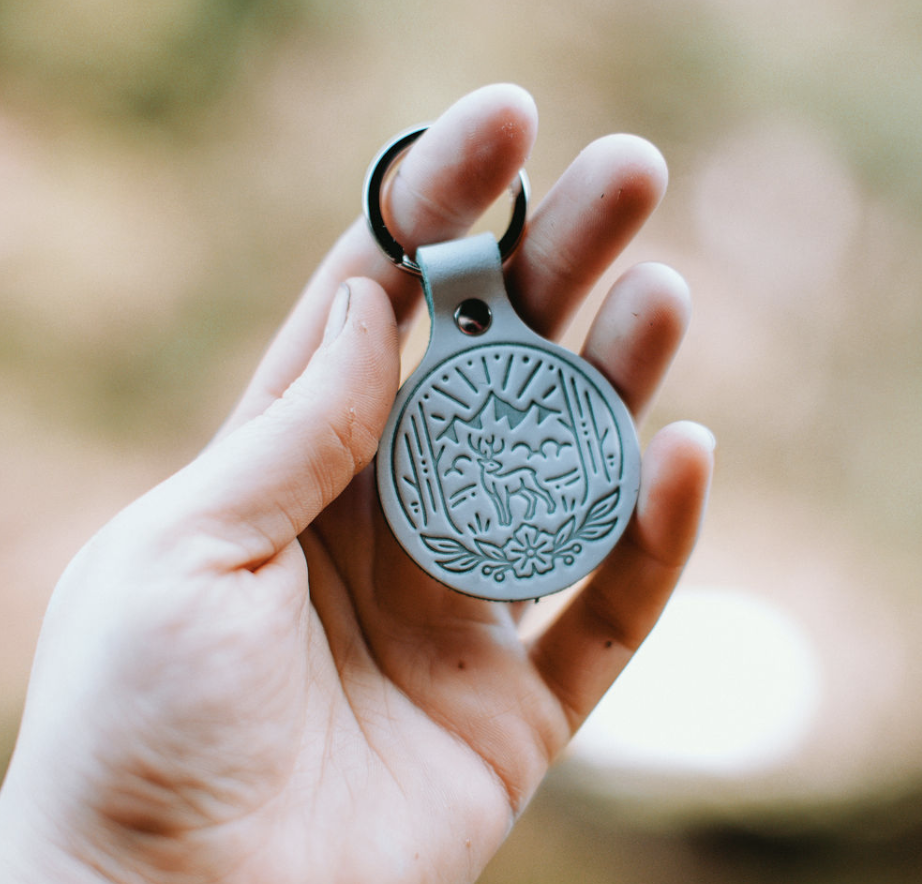 Green leather keychain with mountain forest scene by Good + Well Supply Co