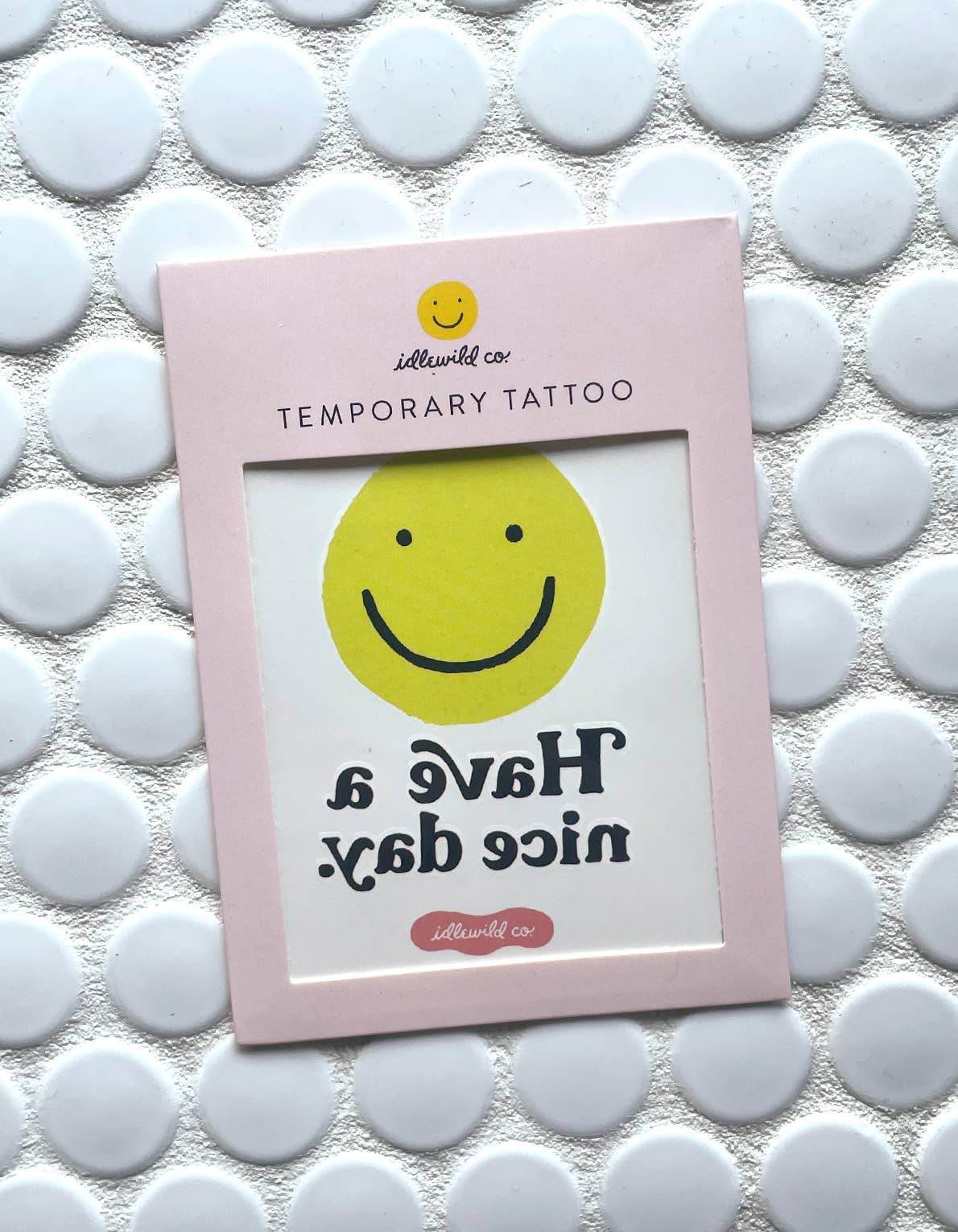 Temporary Tattoo with smiley face and saying "Have a nice day." by Idlewild