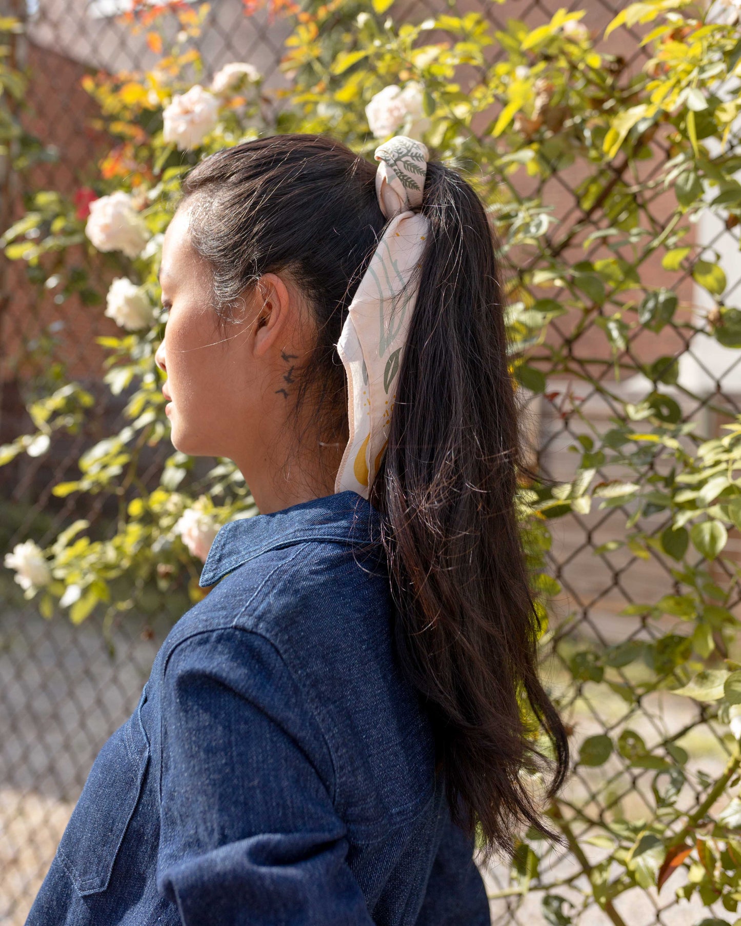Moth and moon bandana by United by Blue used as a hair tie