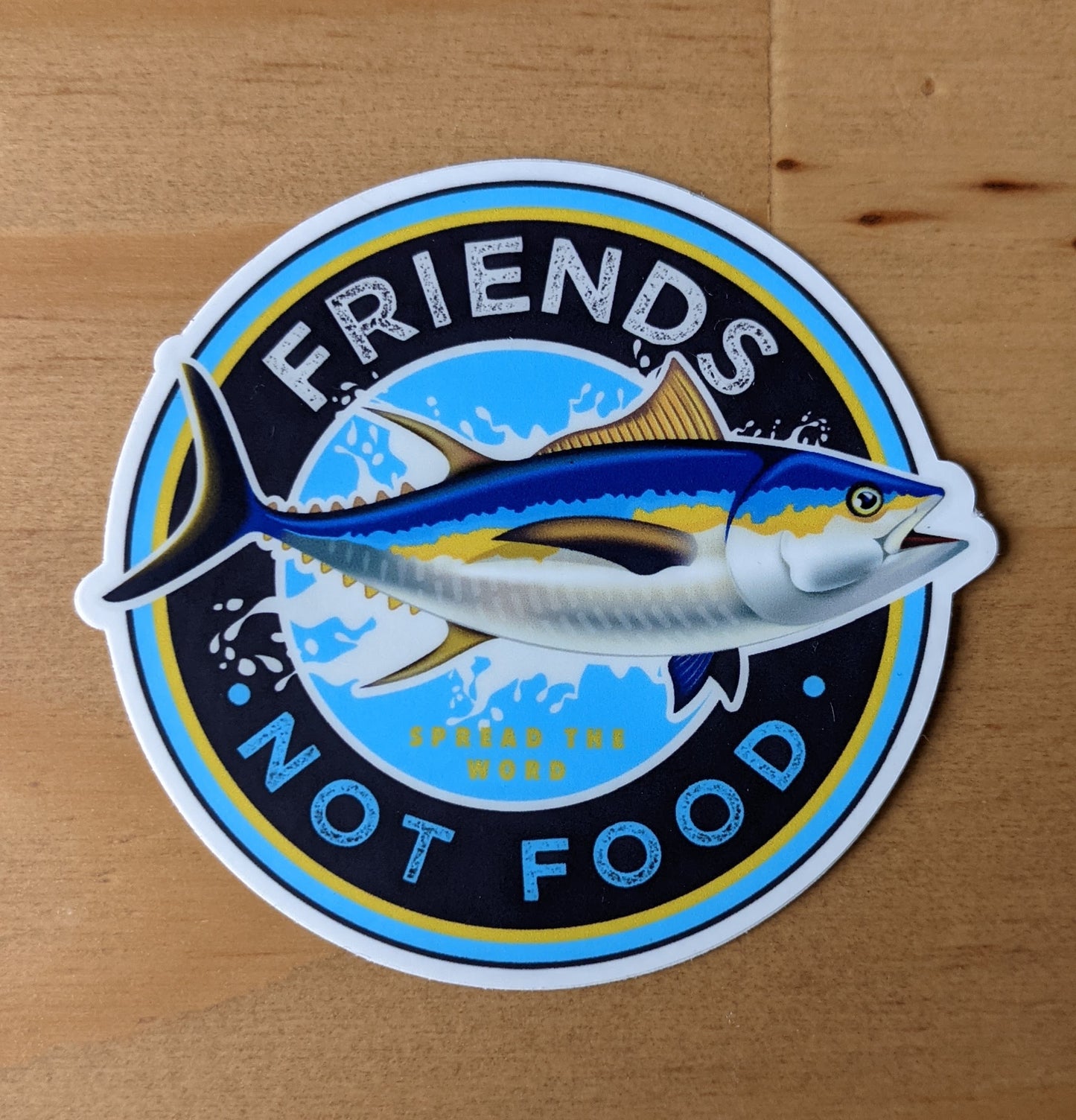 Round sticker reading "Friends, not food" with tuna fish,  created by Jackie from Present