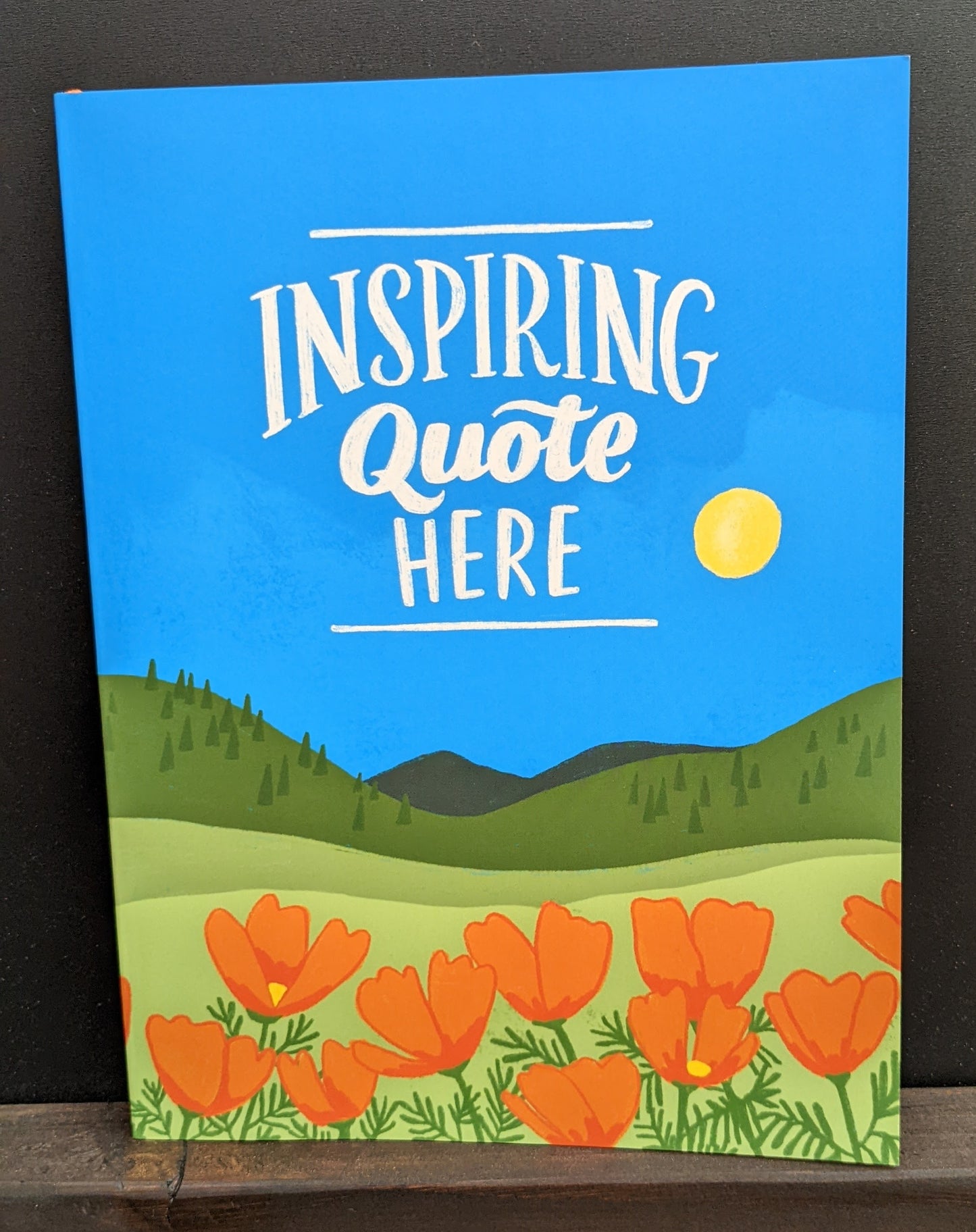 One of Emily McDowell journal designs: "Inspiring Quote Here" with poppy field design"