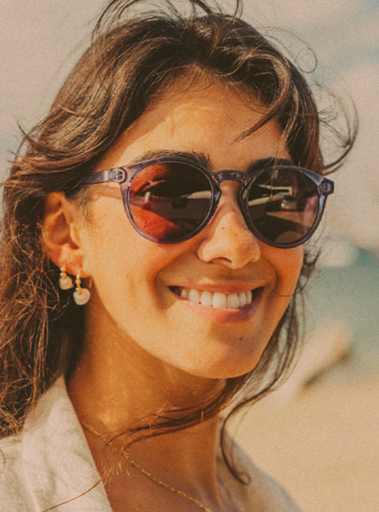 Dipsea Sapphire with rose lenses sunglasses by Sunski on female model