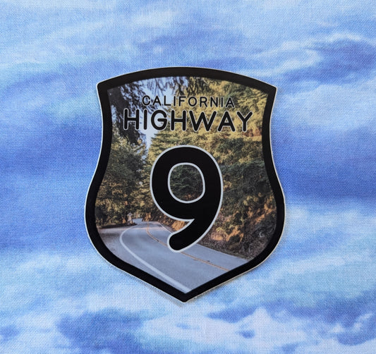 California Highway 9 badge sticker with photo of Highway 9 in the background and black border and text