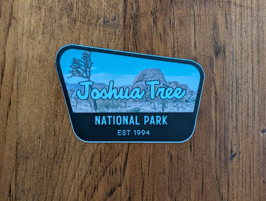 black bordered sticker represents Joshua Tree National Park with wood background