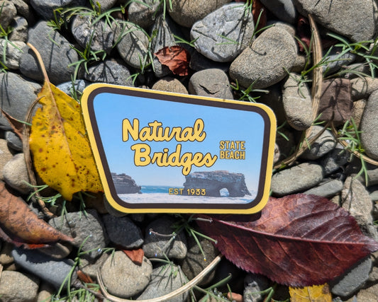 yellow + brown bordered sticker represents Natural Bridges State Beach
