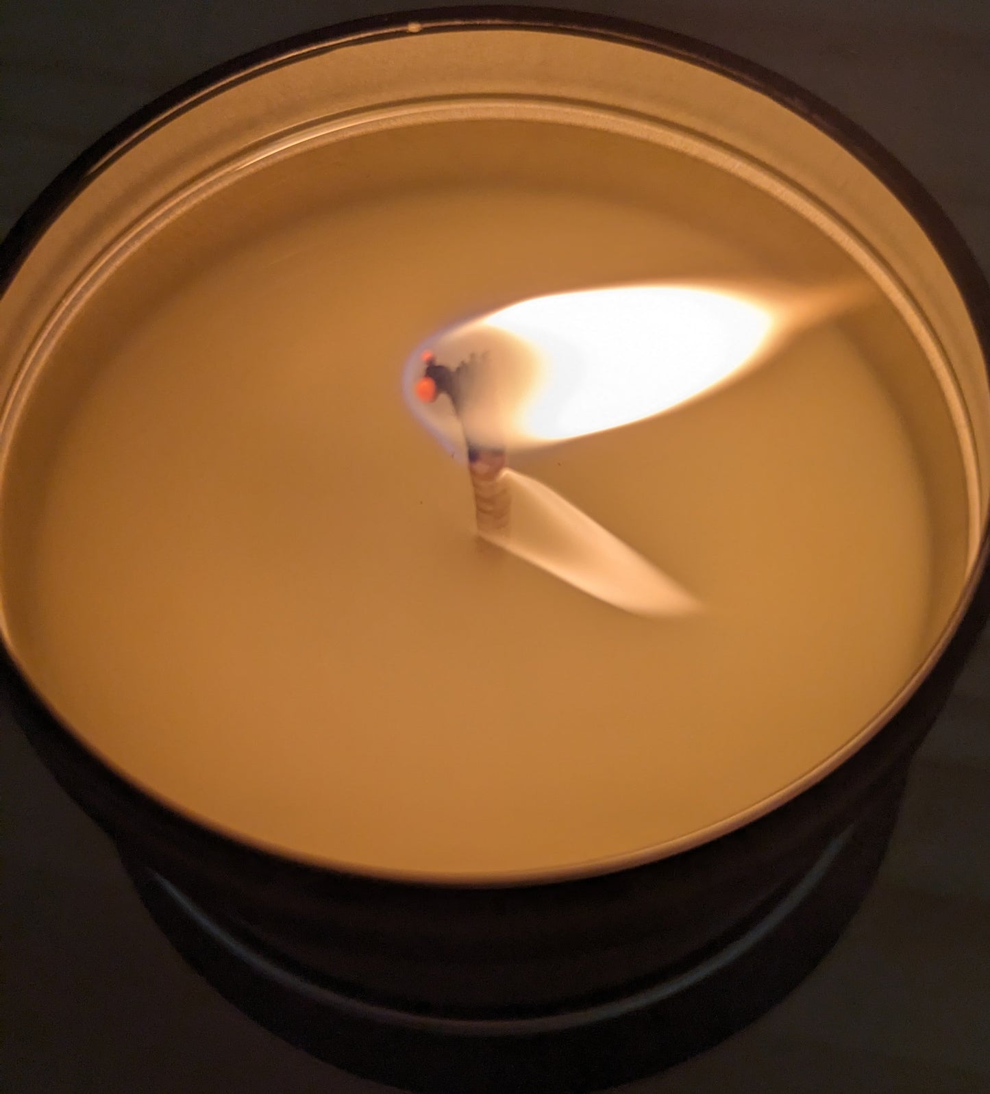 Travel tin candle burning