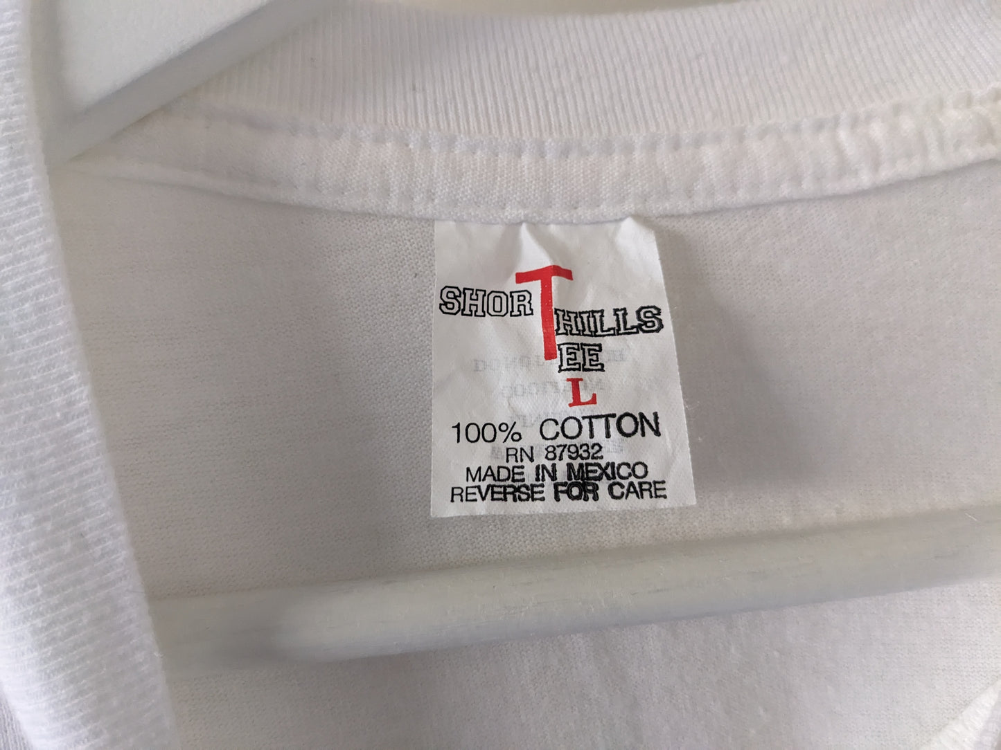 White shirt with Running Horses graphic tag
