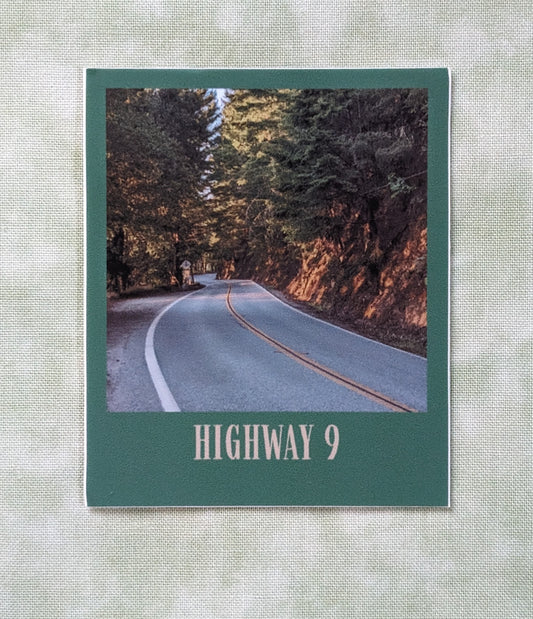 Forest green bordered sticker of photo of Highway 9