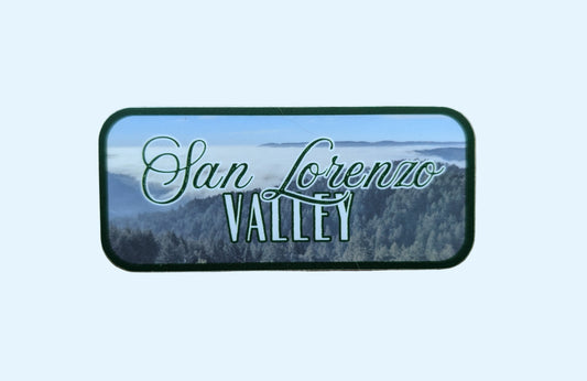 dark green bordered sticker represents SLV or the San Lorenzo Valley with paper background