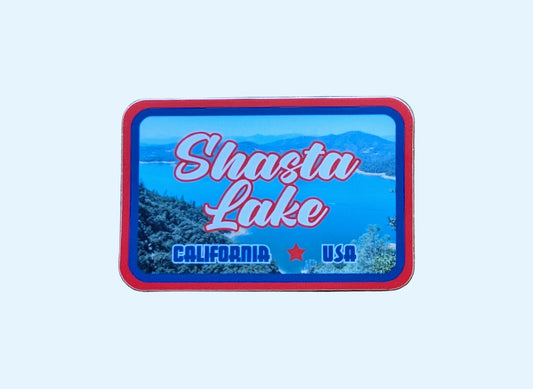 Red and blue-bordered rectangular sticker reads Shasta Lake, California, USA with a photo of this iconic lake in Northern California in the background