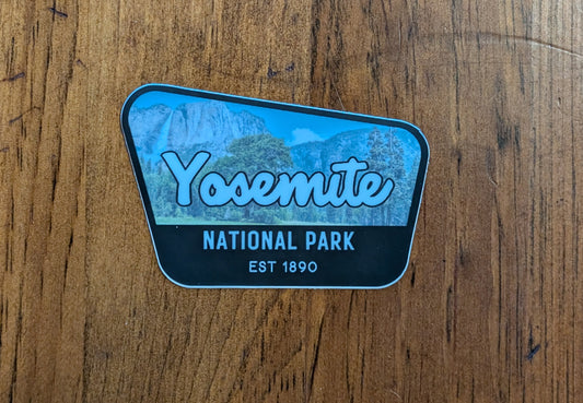 black bordered sticker represents Yosemite National Park in California with wood background