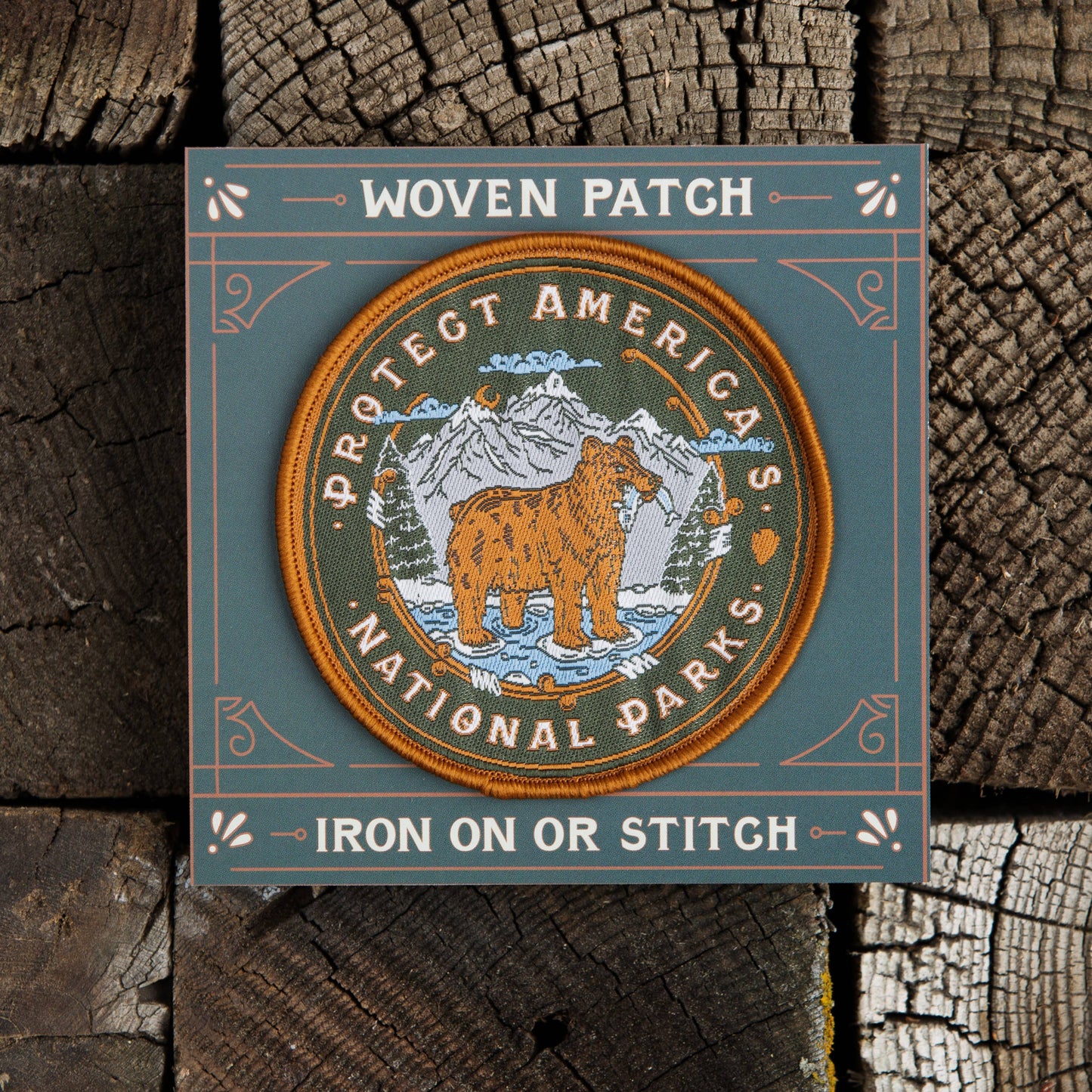 Round patch with bear in the mountains, reading "Protect America's National Parks" by Good + Well Supply Co