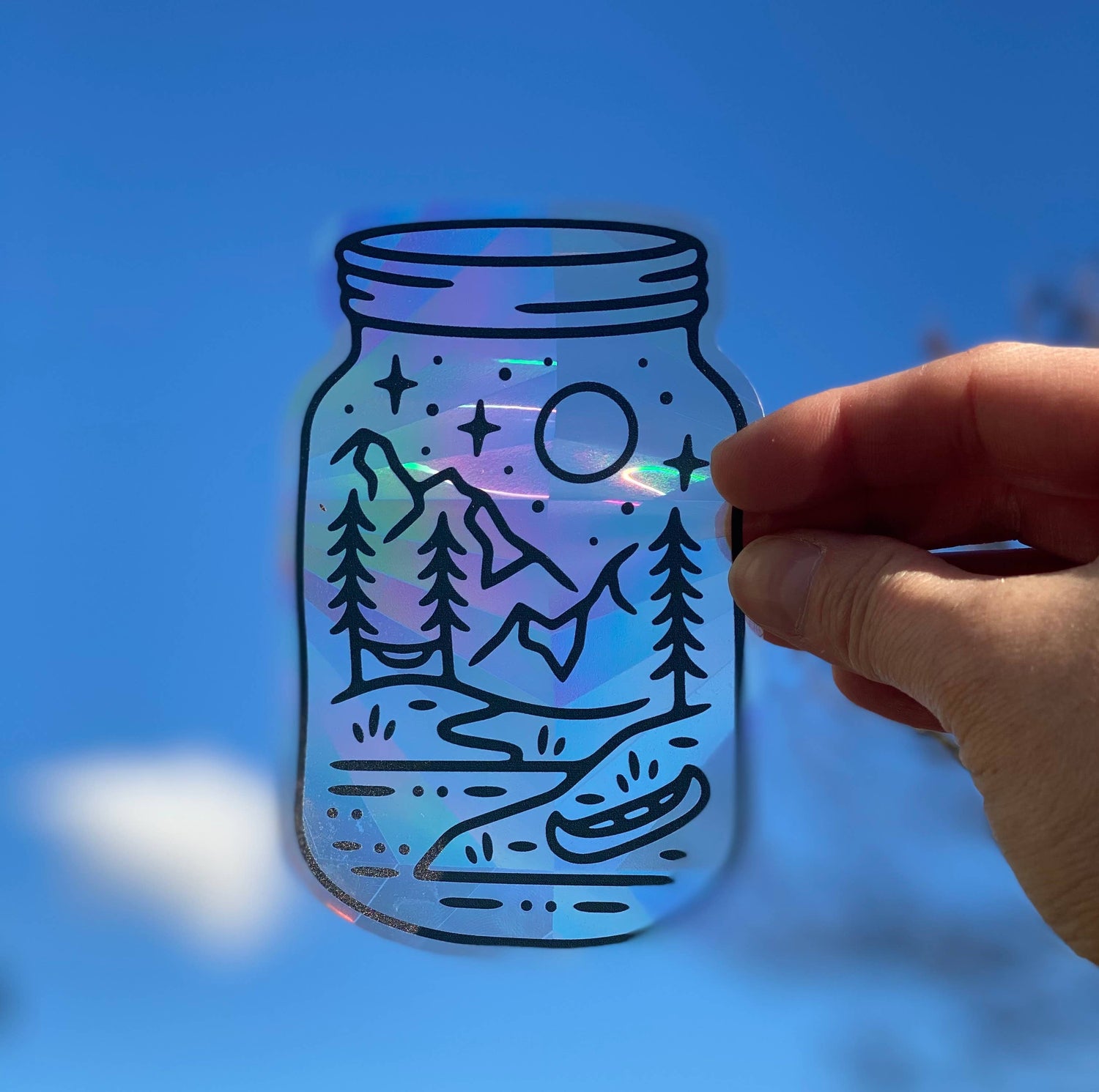 Mason jar shaped suncatcher with mountain lake scene design by Good + Well Supply Co