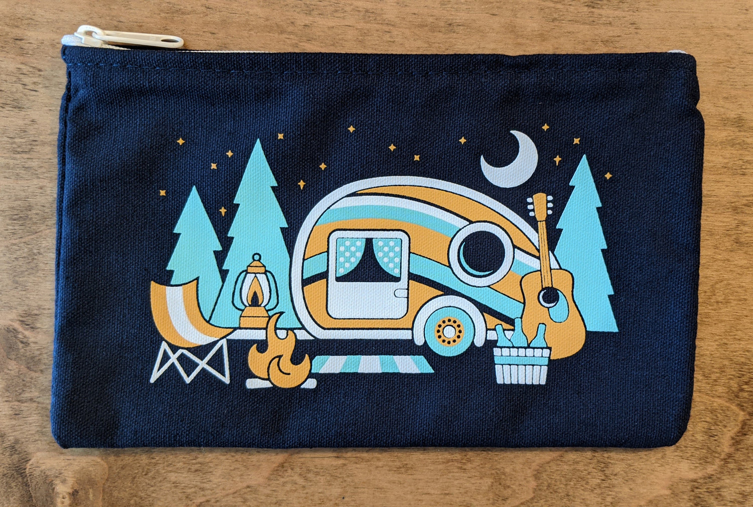 Front of roadtrip pouch by by Poppy & Quail with camping night time scene
