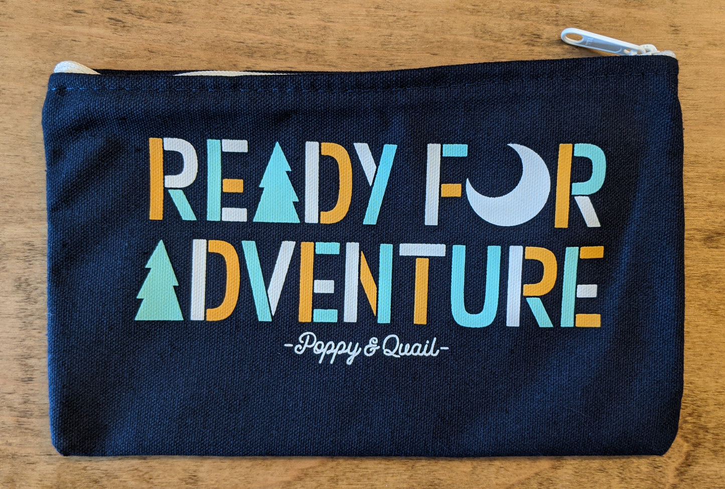 Back of roadtrip pouch in navy blue reading "Ready for adventure"  by Poppy & Quail