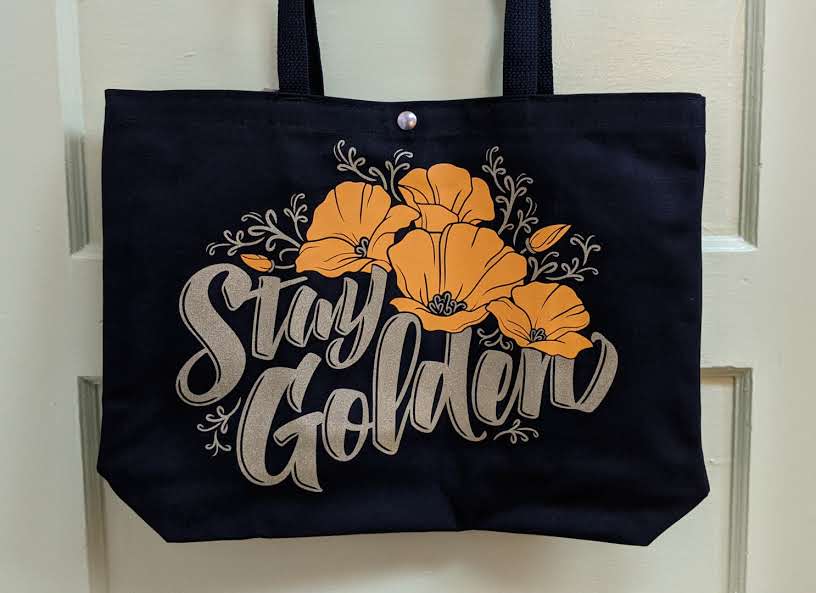 Poppy shopper, black tote bag with poppies and Stay Golden script by Poppy & Quail
