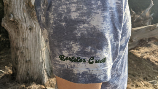 Blue and white tie dye with Boulder Creek in green ink on the sleeve