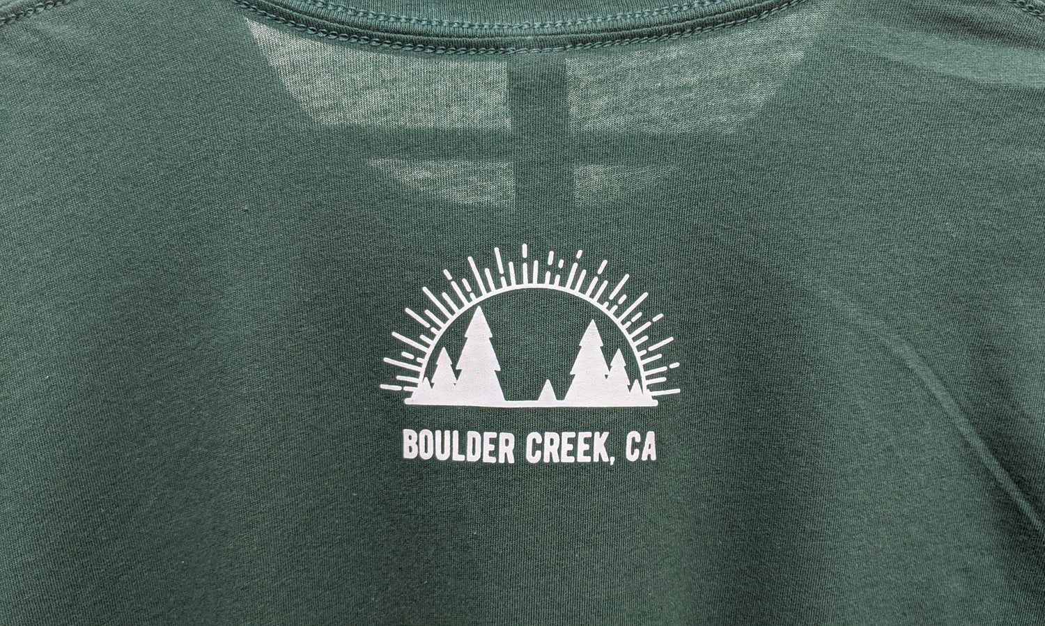 Close up of Boulder Creek, CA with Present logomark on green shirt back