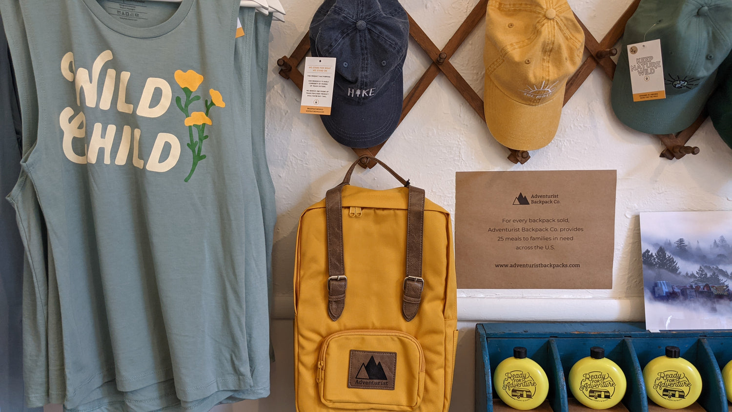 Tank top and hats, alongside Adventurist Classic Backpack in Amber