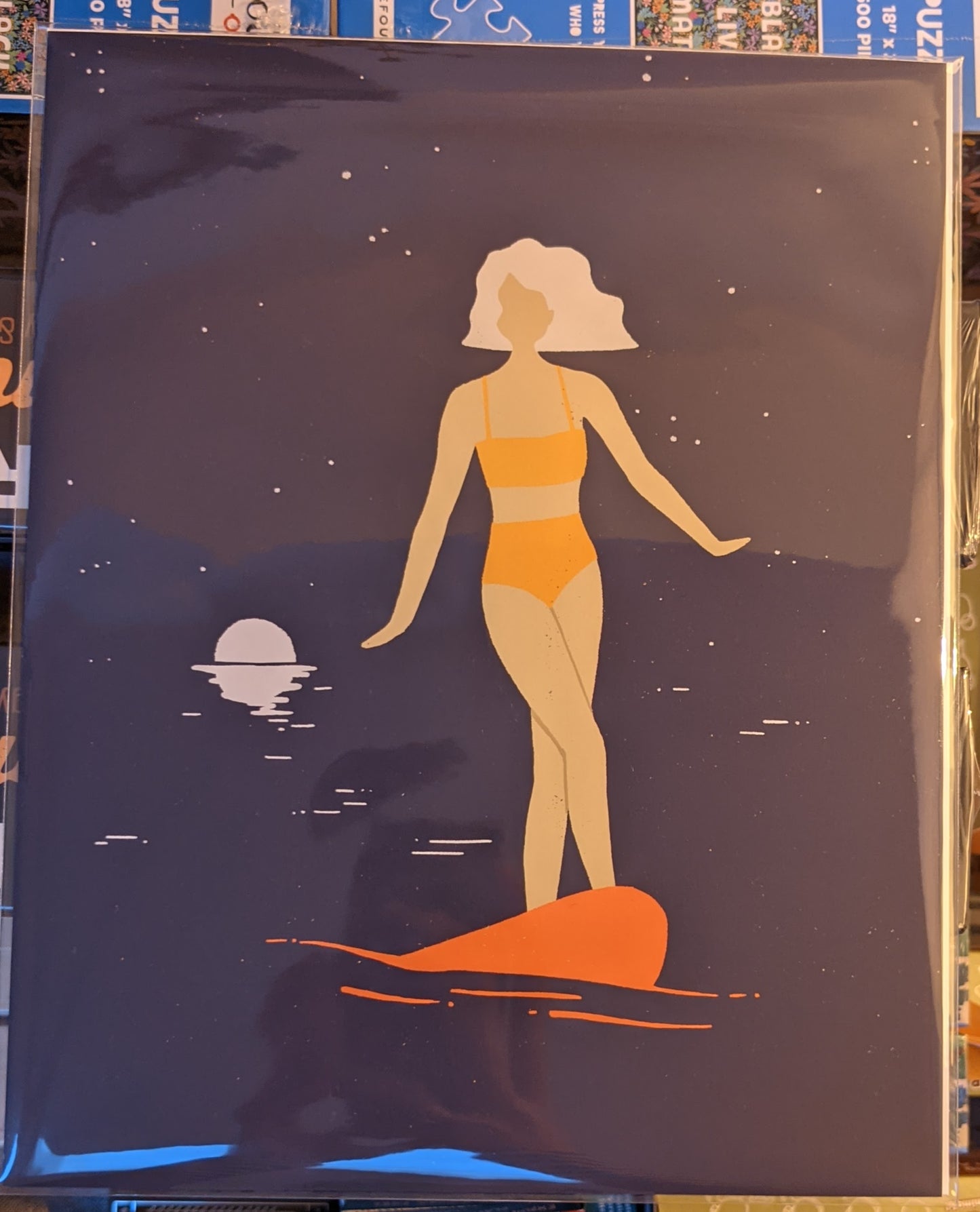 Art Deco print of female surfer on nose of her board at night by Annika Layne