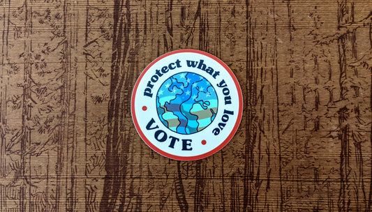 Round sticker reading Protect what you love, Vote with Earth and American flag in center