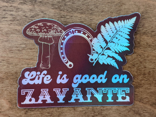 Mountain Talk holographic red sticker reading Life is good on Zayante with mushroom, fern and horseshoe