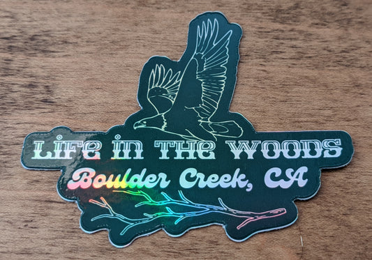 Mountain Talk holographic green sticker reading Life in the woods, Boulder Creek, CA with eagle design