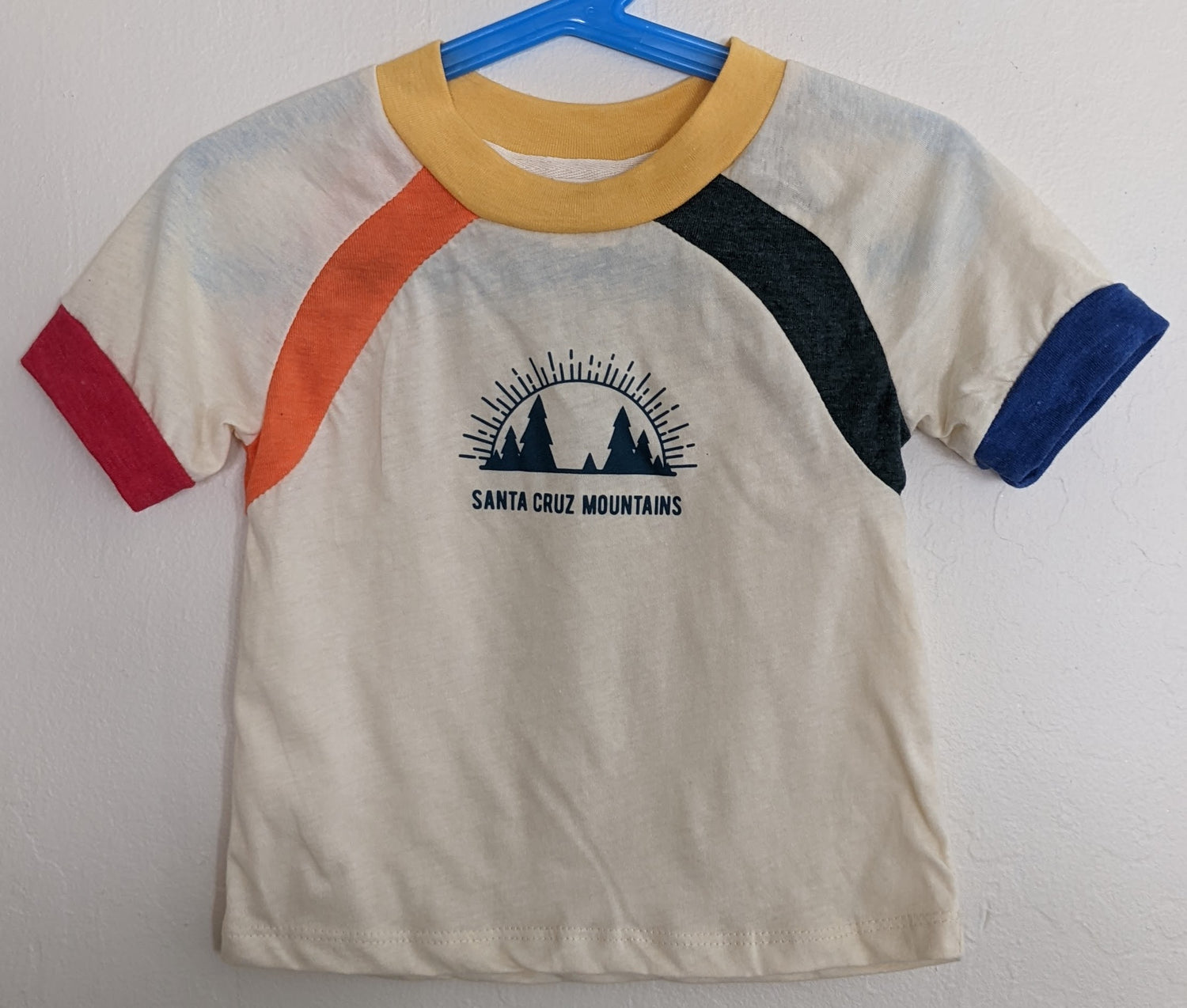 White kids shirt by Camp Collection with rainbow accents and Santa Cruz Mountains Present logo mark design on front,  created by Jackie from Present