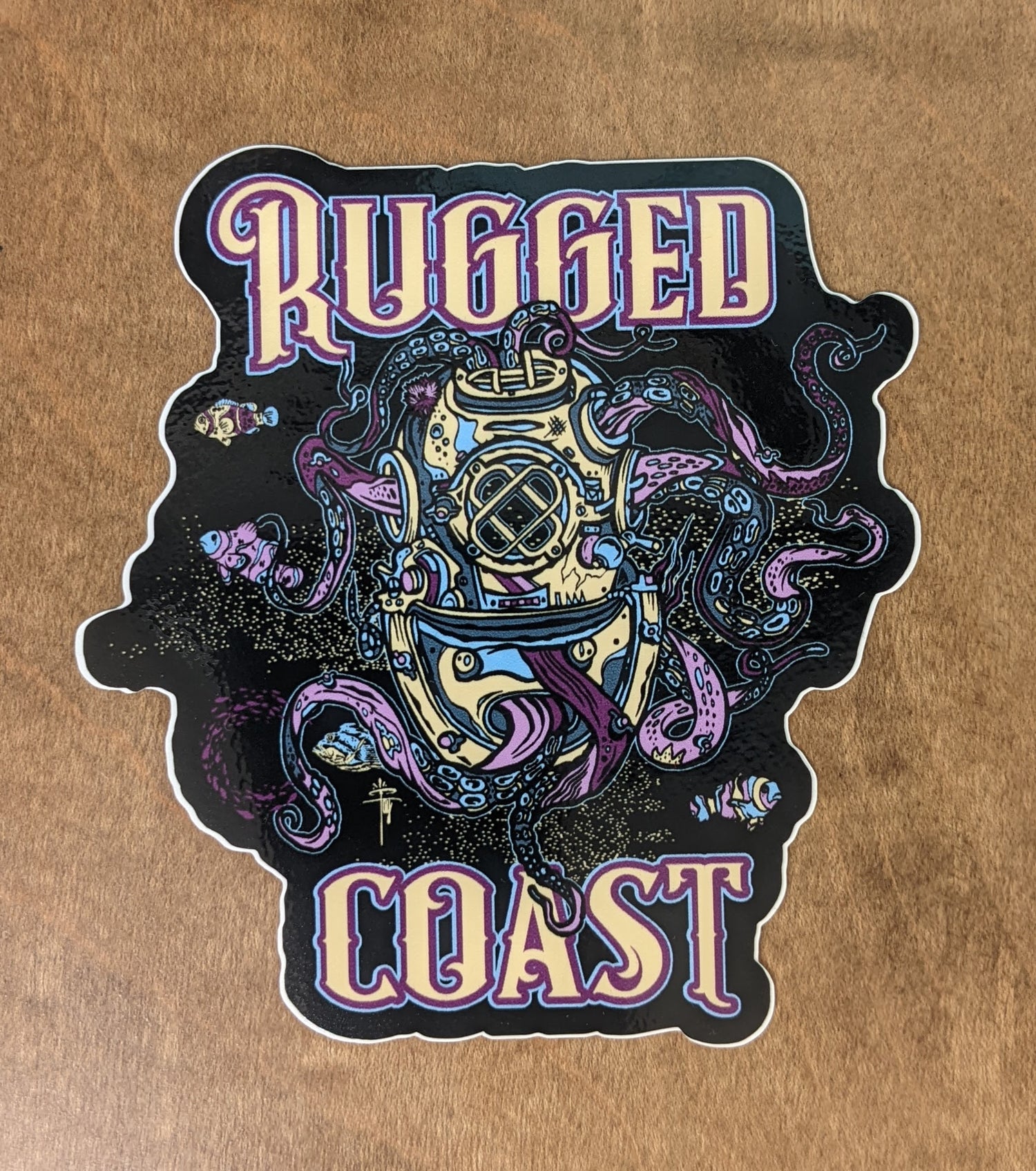 Rugged Coast logo sticker in black, yellow and purple