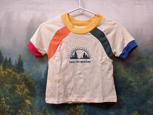 White kids shirt by Camp Collection with rainbow accents and Santa Cruz Mountains Present logo mark design on front,  created by Jackie from Present