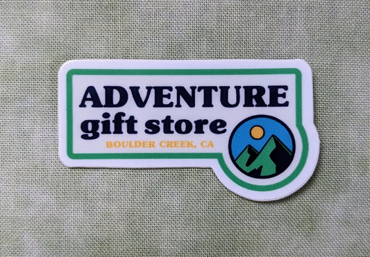 Small sticker reads Adventure Gift Store, Boulder Creek, CA with mini mountain sun circle