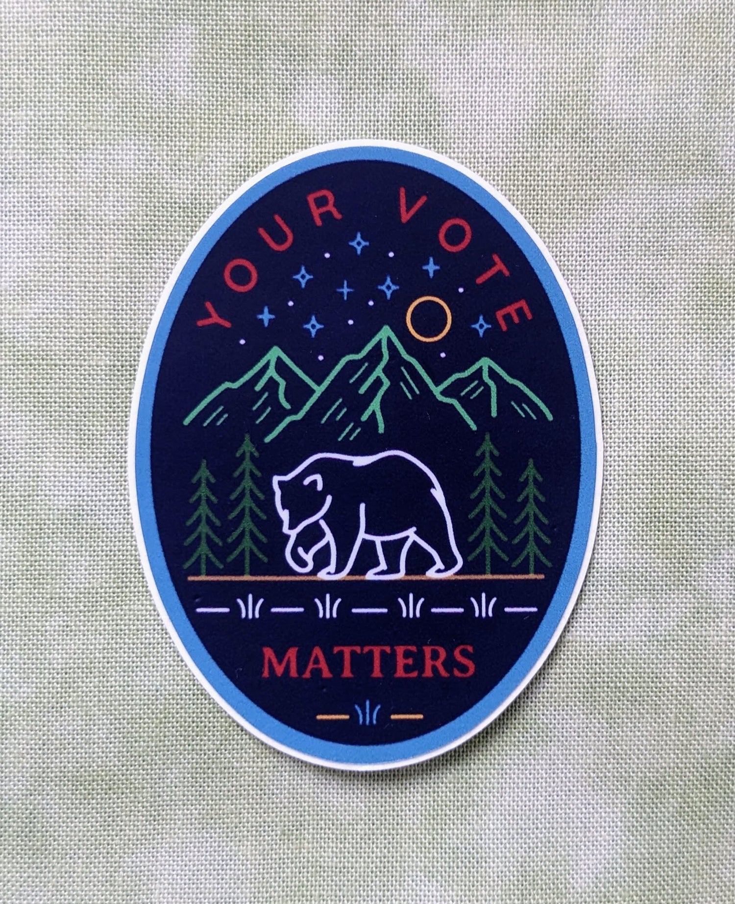 Navy Oval sticker with Your Vote Matters with bear and mountains