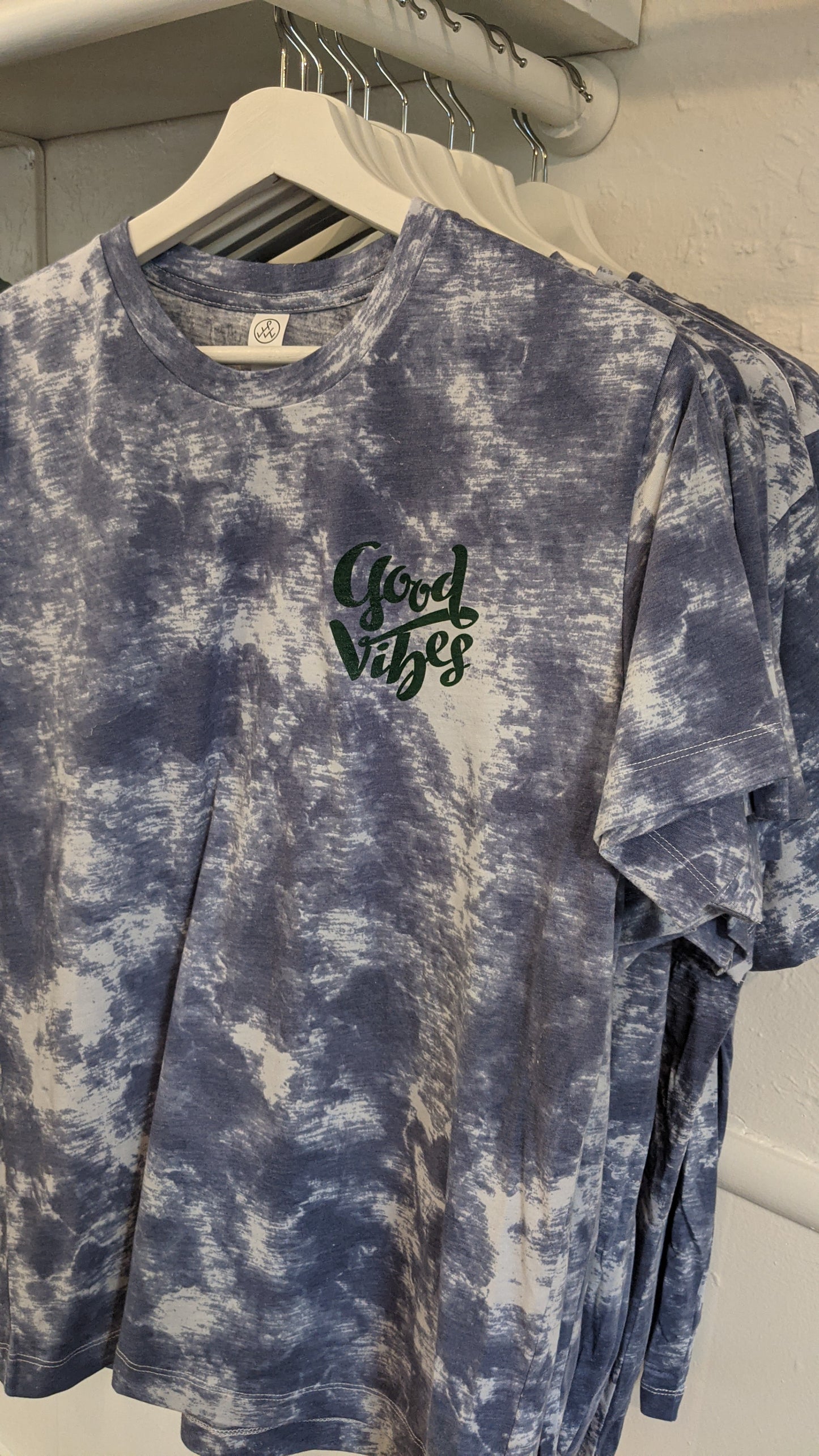 Blue and white tie dye shirt with Good Vibes design on front